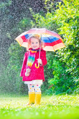 Wall Mural - Little cute girl playing in the rain