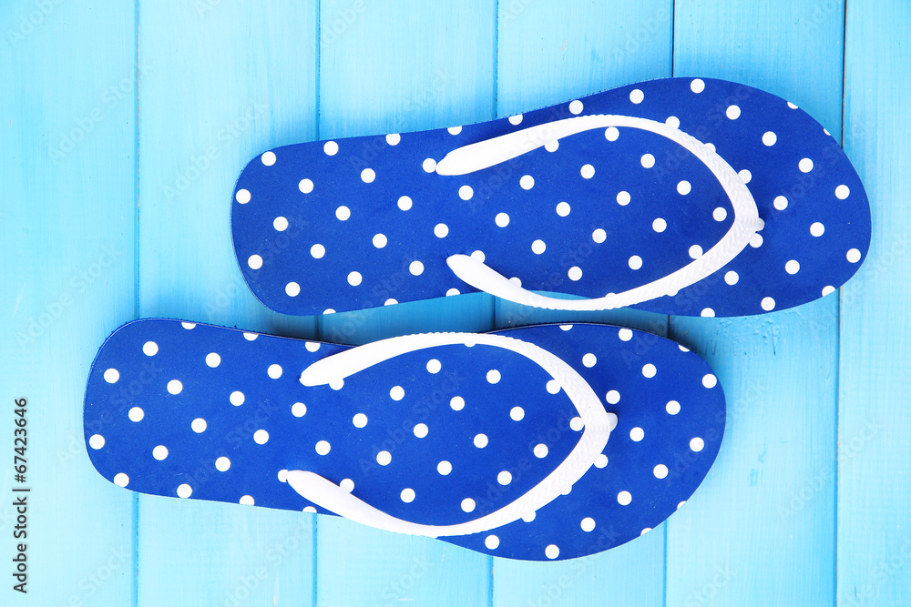Color flip-flops on wooden background