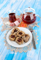 Wall Mural - Sweet baklava on plate with tea on table