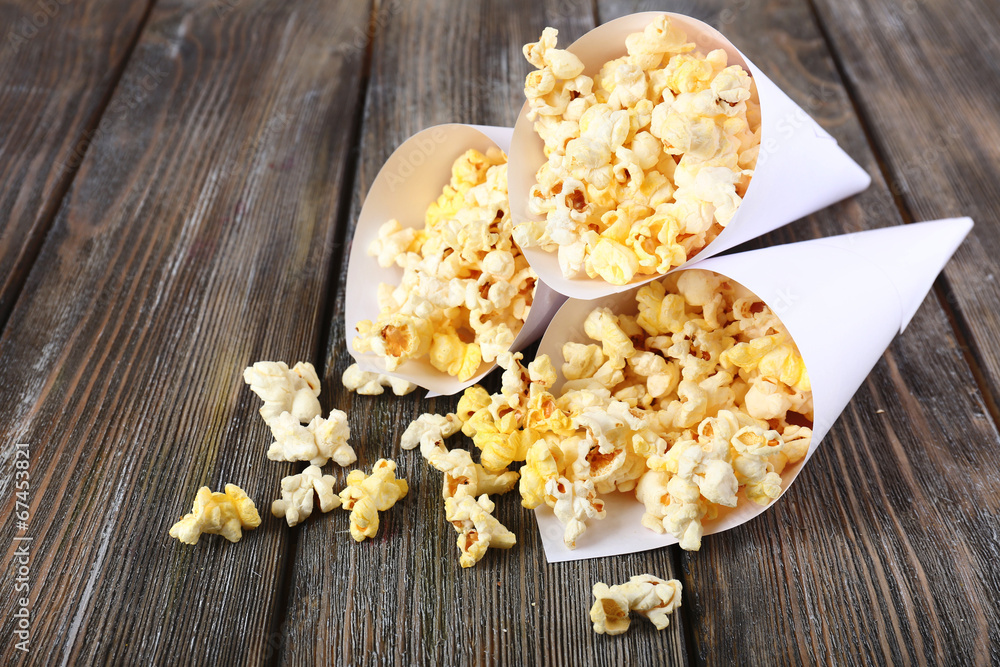 Popcorn on wooden table, close up