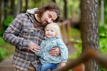 Wall Mural - Happy father holding his little daughter