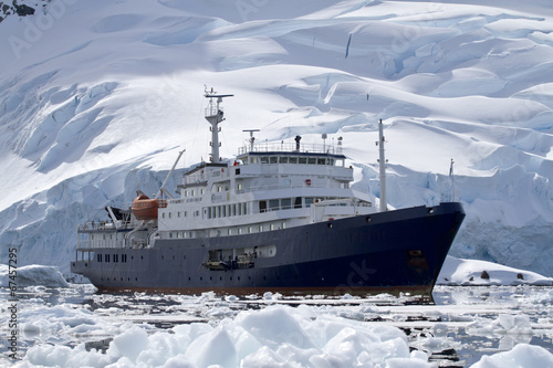 Fototapeta dla dzieci big blue tourist ship in Antarctic waters against the backdrop o