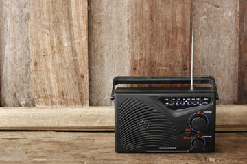 Old transistor radio on wooden background