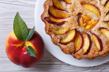 Wall Mural - fruit tart and fresh peach closeup top view