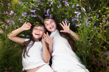 Portrait of two young girlfriends with flowers