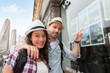© Production Perig - Young happy couple in front of travel agency