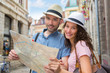 © Production Perig - Couple of young attractive tourists watching map