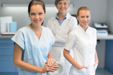 Wall Mural - Three dentist woman team at dental surgery