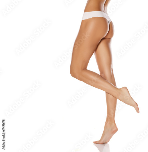Cuadros en Lienzo pretty female legs and white panties on white background