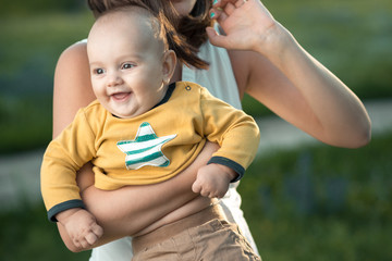 Wall Mural - Happy mother holding a young son