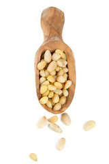 Poster - pine nuts in a wooden scoop isolated on white background