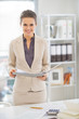 © Alliance - Portrait of happy business woman working in office
