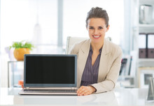 Happy Business Woman Showing Laptop Blank Screen