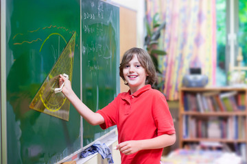 School adorable child at math class