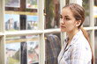 © highwaystarz - Disappointed Young Woman Looking In Window Of Estate Agents