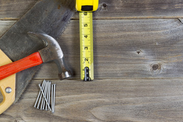 Basic home repair tools on weathered wood