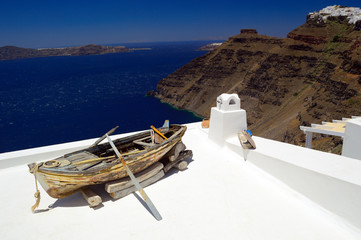 Wall Mural - Wooden boat on a roof in Santorini, Cyclades, Greece