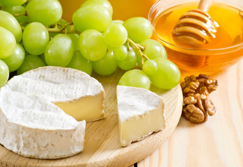 Wall Mural - Still life of cheese, honey, walnuts and grapes