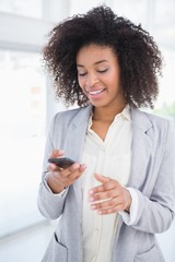 Wall Mural - Casual businesswoman texting on phone