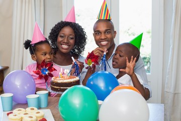 Happy family celebrating a birthday together at table