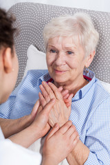 Wall Mural - Nurse comforting elderly woman