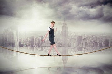 Poster - Composite image of businesswoman doing a balancing act on tightr
