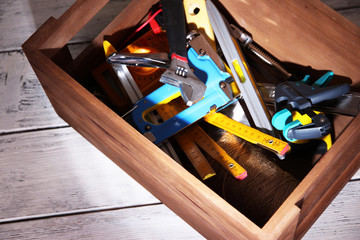 Canvas Print - Wooden box with different tools, on wooden background