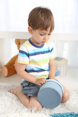 Cute little boy playing in room