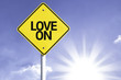 © gustavofrazao - Love On road sign with sun background