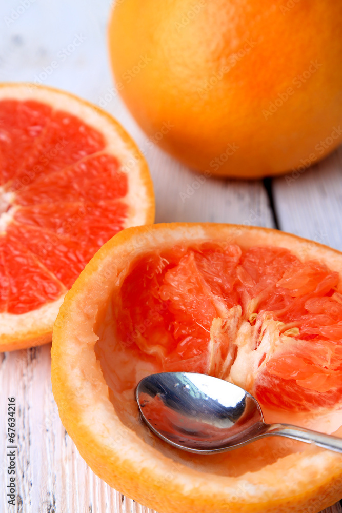 Ripe grapefruits on color wooden background