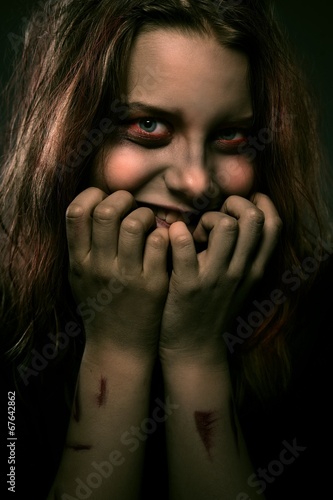 Fotomural Girl possessed by a demon with a sinister smile