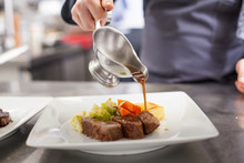 Chef Plating Up Food In A Restaurant