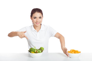 Asian girl smile point to salad push crisps away