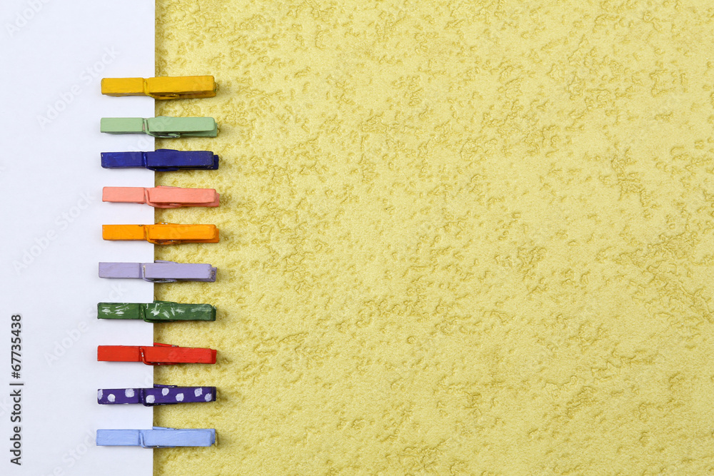 Abstract background with colorful wooden pins and paper