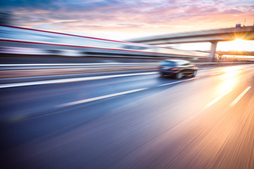 Car driving on freeway at sunset, motion blur