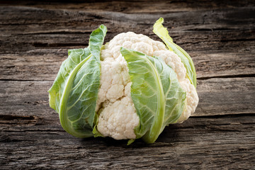 Fresh organic cauliflower on wooden background