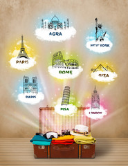 Wall Mural - Tourist suitcase with famous landmarks around the world