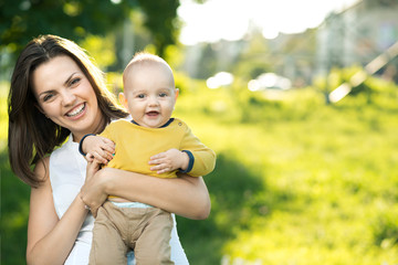 Wall Mural - Happy mother holding a young son