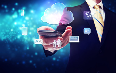 Wall Mural - Business man holding a mobile phone with cloud connection theme