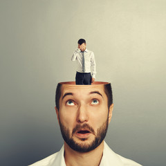 Canvas Print - young businessman with sad small man