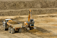 Digger Filling Truck With Soil