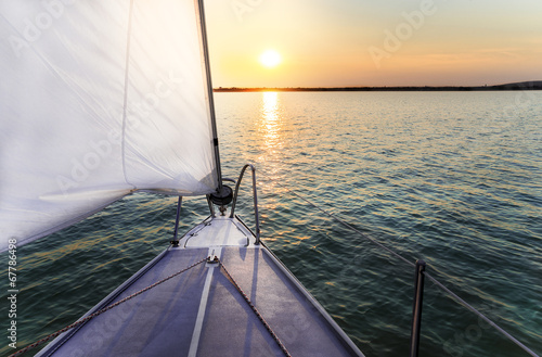 Naklejka na meble Sailing to the sunset with a luxury yacht.