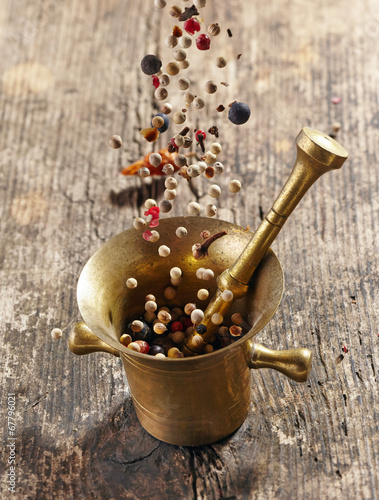 Nowoczesny obraz na płótnie various spices falling into mortar and pestle