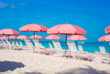 Cute Umbrellas And Sunbeds At Tropical Beach