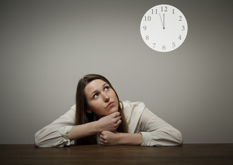 Girl in white and a clock showing several minutes to twelve.
