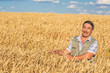 © Ryzhkov Oleksandr - farmer standing in a wheat field