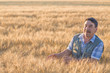 © Ryzhkov Oleksandr - farmer standing in a wheat field