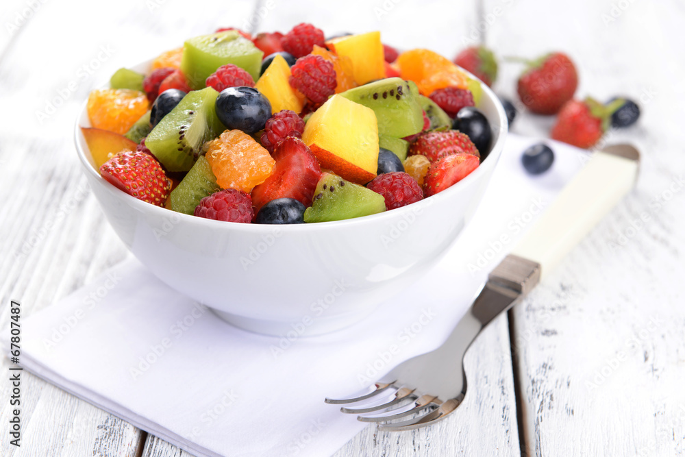 Delicious fruits salad in plate on table close-up
