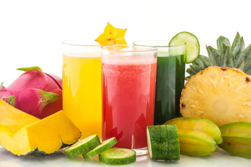 Raw fruit and fruit juice on white