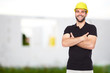 © Rostislav Sedlacek - Young smiling builder standing before building